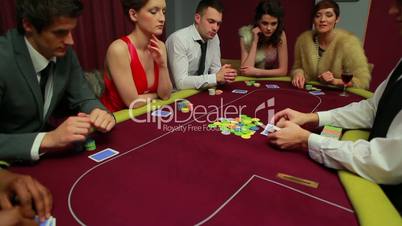 People playing poker waiting for dealer
