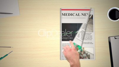 Hand turning pages of medical news magazines