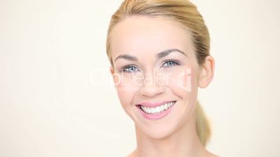 Blonde woman smiling facing forwards