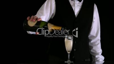 Waiter filling champagne flute