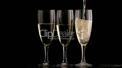 Three champagne flutes topped up