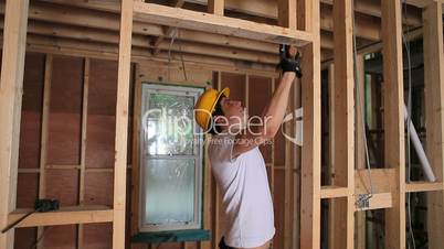 Builder hammering door frame