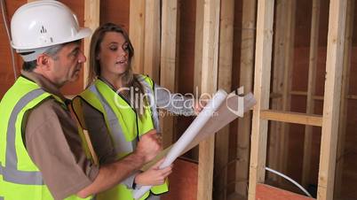 Architect discussing plan with builder