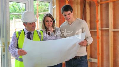 Architect and couple perusing the plan