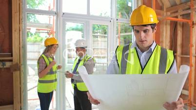 Male architect reading the plan