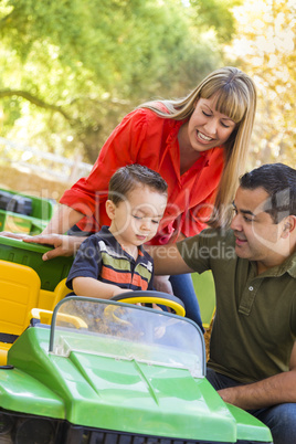 Young Mixed Race Boy Enjoys Toy Tractor with Parents