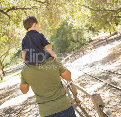 Mixed Race Son Enjoy a Piggy Back in the Park with Dad