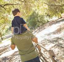 Mixed Race Son Enjoy a Piggy Back in the Park with Dad