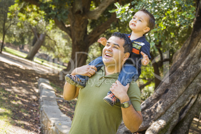 Mixed Race Son Enjoy a Piggy Back in the Park with Dad