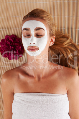 Woman with a face mask in a spa