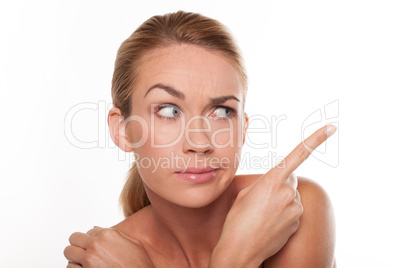 Sceptical woman pointing with her finger