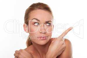 Sceptical woman pointing with her finger