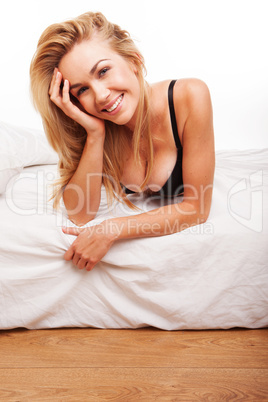 Sexy smiling blonde on her bed