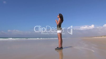 attractive woman doing gymnastics on the beach