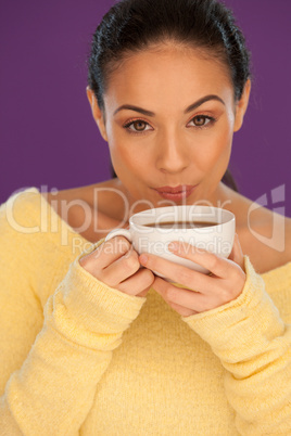 Woman cooling down her coffee