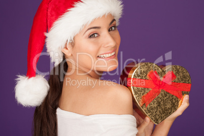 Happy woman with a Christmas heart gift