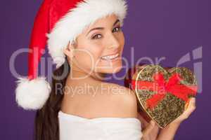 Happy woman with a Christmas heart gift