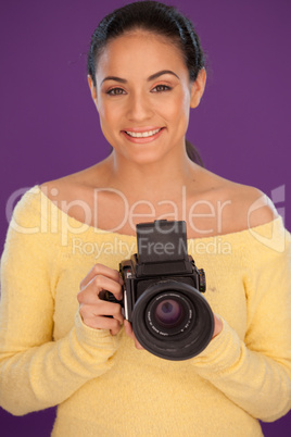 Smiling woman with vintage camera