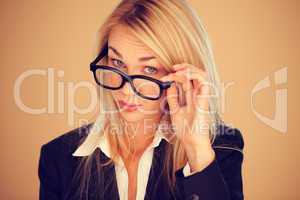 Businesswoman peering over her glasses