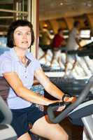 Woman on the ergometer in the gym