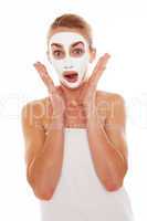 Woman in face mask with surprised expression
