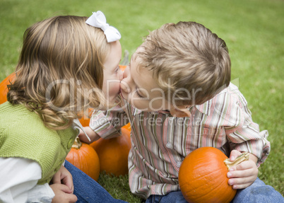 Cute Young Brother and Sister Kiss At the Pumpkin Patch