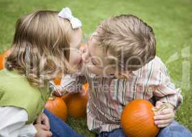 Cute Young Brother and Sister Kiss At the Pumpkin Patch