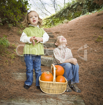 Brother and Sister Children on Wood Steps with Pumpkins Singing