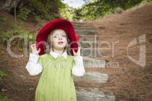 Adorable Child Girl with Red Hat Playing Outside