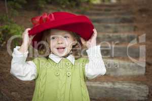 Adorable Child Girl with Red Hat Playing Outside