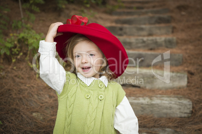 Adorable Child Girl with Red Hat Playing Outside