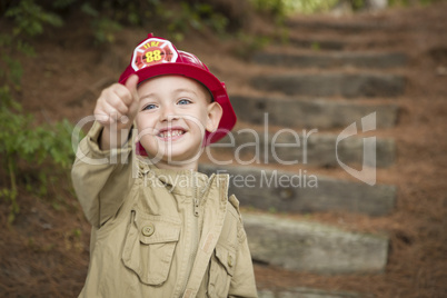 Adorable Child Boy with Fireman Hat Playing Outside