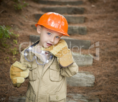 Adorable Child Boy with Big Gloves Playing Handyman Outside