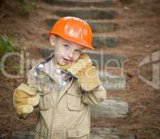 Adorable Child Boy with Big Gloves Playing Handyman Outside