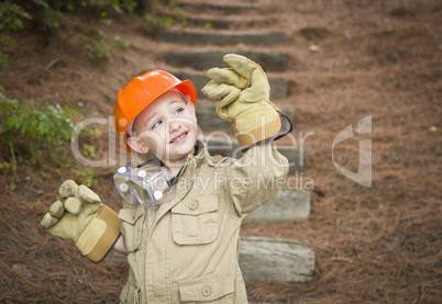 Adorable Child Boy with Big Gloves Playing Handyman Outside