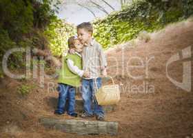 Two Children with Basket Hugging Outside on Steps
