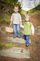 Two Children Walking Down Wood Steps with Basket Outside.
