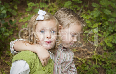 Adorable Brother and Sister Children Hugging Outside