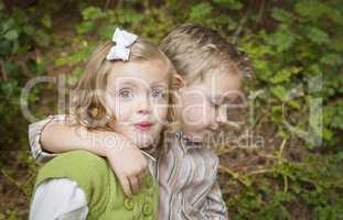 Adorable Brother and Sister Children Hugging Outside