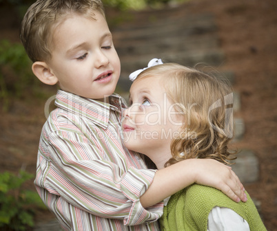 Adorable Brother and Sister Children Hugging Outside