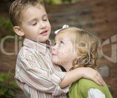 Adorable Brother and Sister Children Hugging Outside