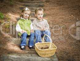 Two Children on Wood Steps with Basket of Pine Cones