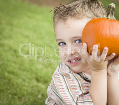 Cure Young Child Boy Enjoying the Pumpkin Patch.