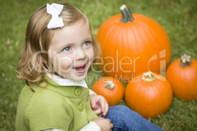 Cure Young Child Girl Enjoying the Pumpkin Patch.