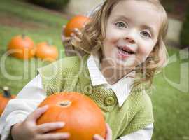 Cure Young Child Girl Enjoying the Pumpkin Patch.