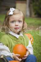 Cure Young Child Girl Enjoying the Pumpkin Patch.
