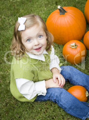 Cure Young Child Girl Enjoying the Pumpkin Patch.