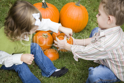 Cute Young Brother and Sister At the Pumpkin Patch