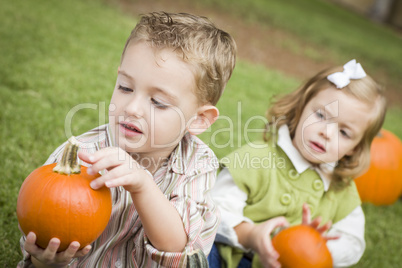 Cute Young Brother and Sister At the Pumpkin Patch