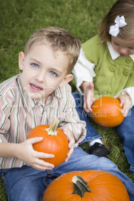 Cute Young Brother and Sister At the Pumpkin Patch